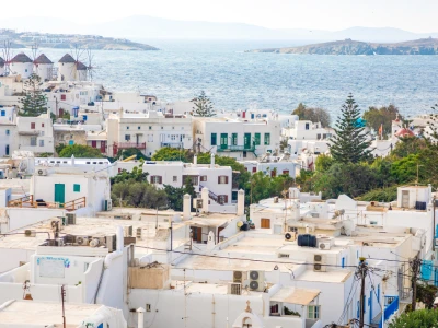 Panoramic view over Mykonos town with white architecture and mills in Greece