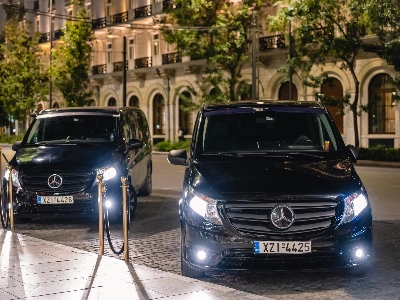 Two black mercedes vitos with lights on