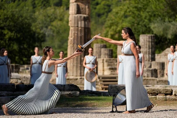 Ancient Olympia exchange of holy flame between 2 white dressed women