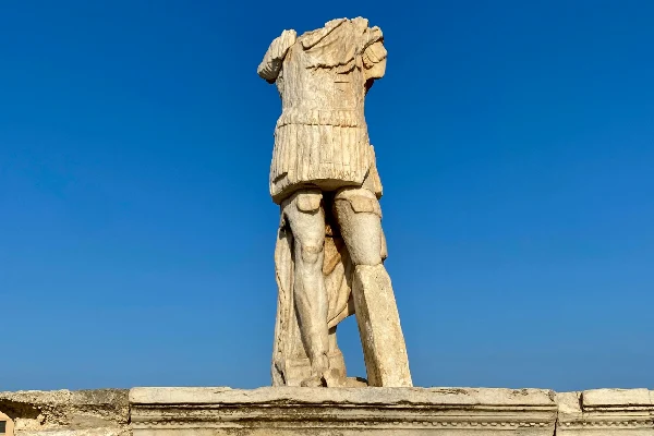 Ancient Sculpture against in Delos, Greece