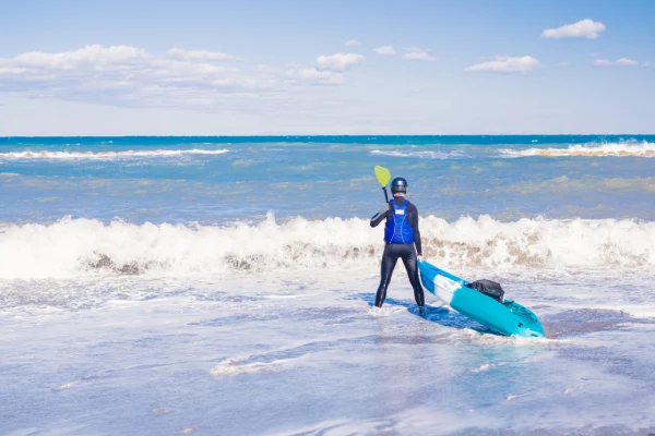 Man with kayak. Traveling by kayak. Leisure activities on the water