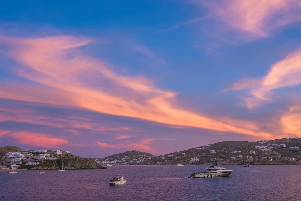 Sunset in Mykonos, Greece and yachts in the harbor